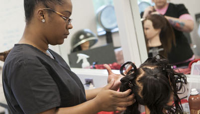 cosmetology student working on hair