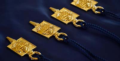 Phi Theta Kappa Gold Pins on blue velvet