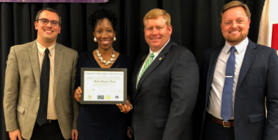 Andrea G. Bowden-Evans holds certificate in group photo