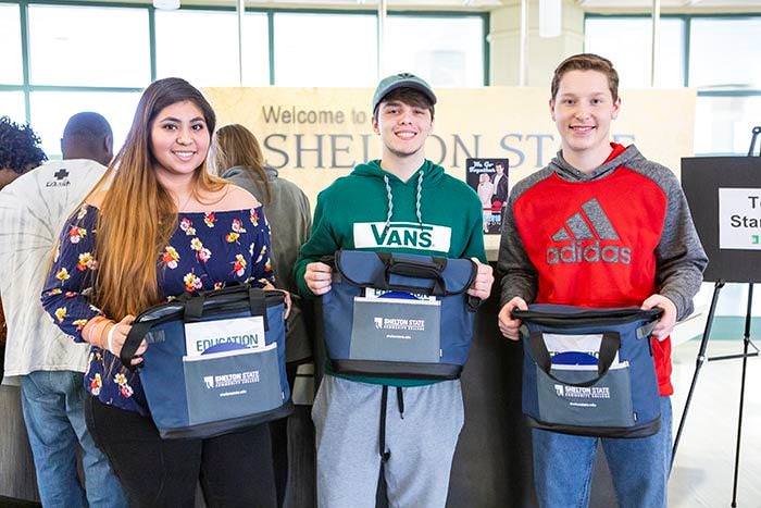 Three students with Shelton State bags