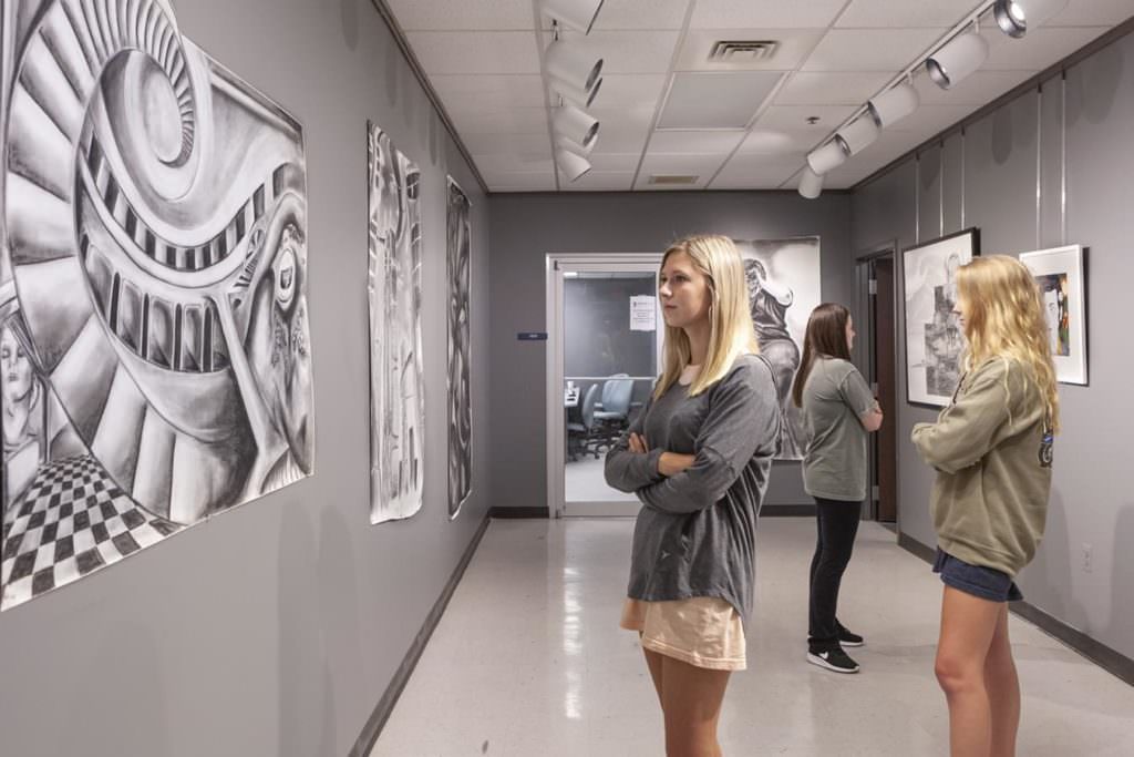 Woman looks at art in gallery