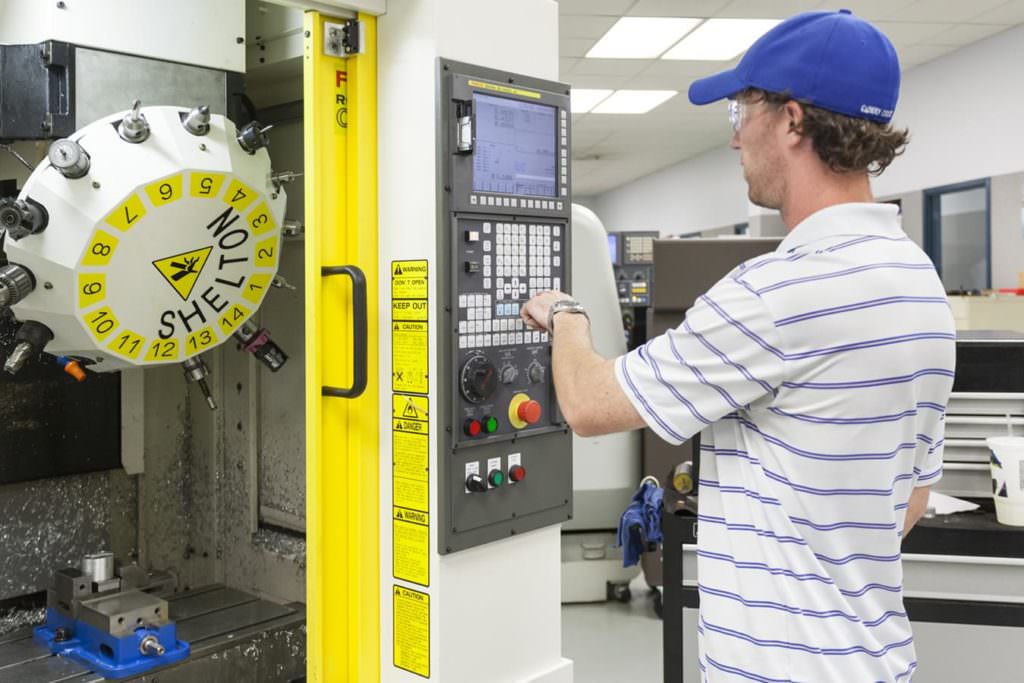 Student working with CNC machine